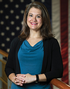 Kuipers stands in front of an American flag