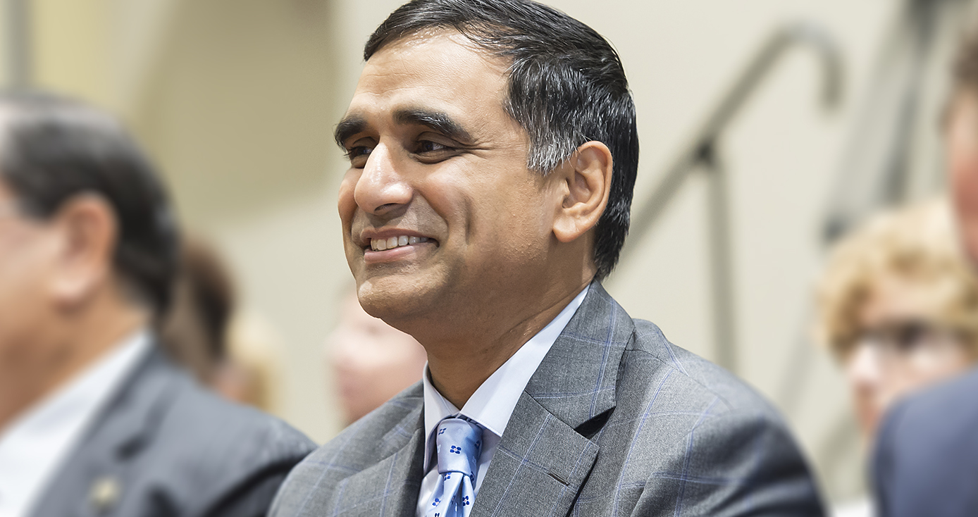 Hari Sastry in a gray suit and light blue tie