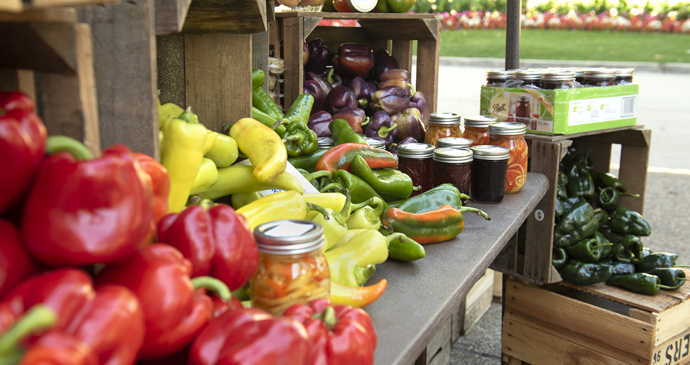 Outdoor table piled with an array of vegetables at Farmers Market at Pitt