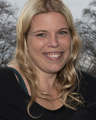 a woman in a black shirt smiling