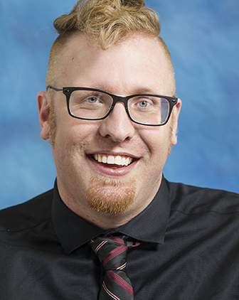 A man in a black dress shirt and tie