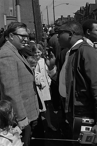 Barbour interviewing a white man in a crowd