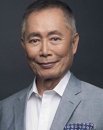 Takei in a gray suit