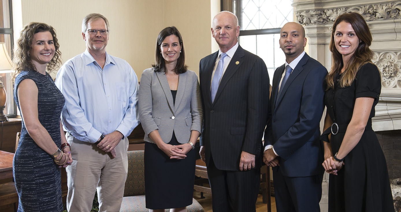 Six staff members of Cyber Institute standing in posed group portrait.