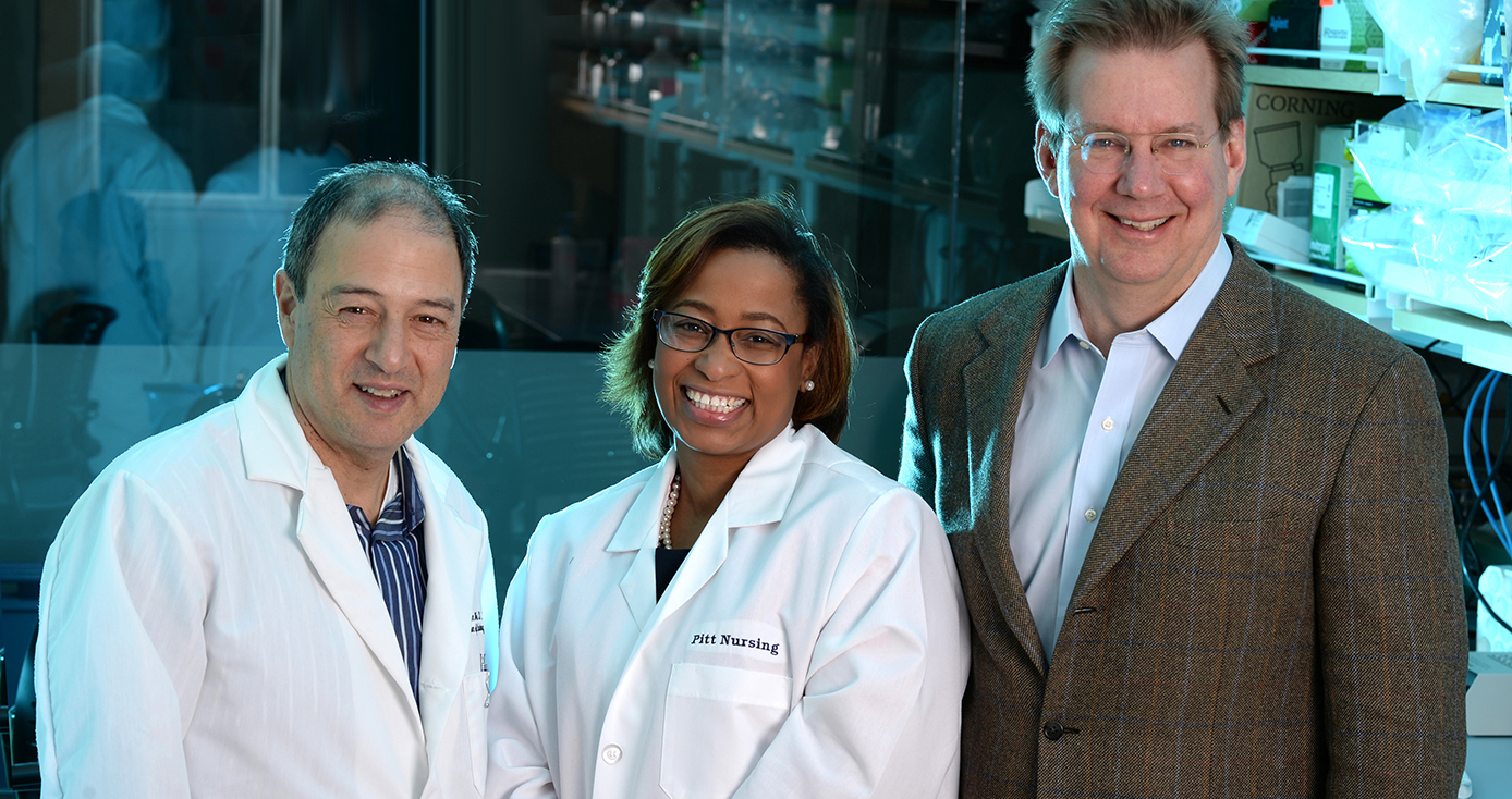 three smiling researchers