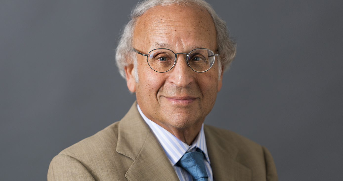 Arthur S. Levine headshot, wearing tan suit jacket, striped collared shirt, and blue tie