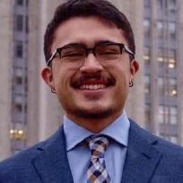 Macadangdang in a blue suit, light blue shirt and checked tie