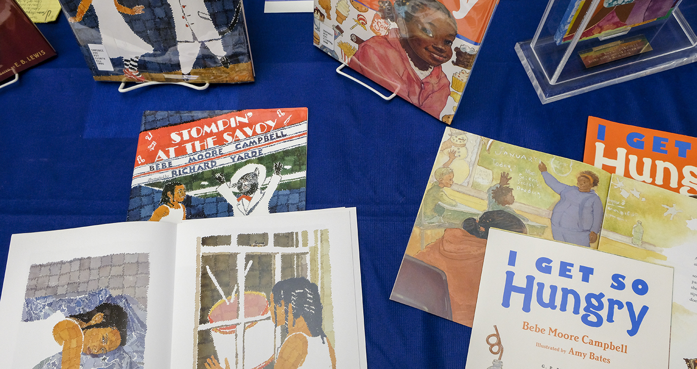 a scattering of books written by Campbell spread on a blue tablecloth