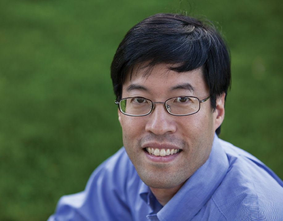 man with glasses smiling at the camera