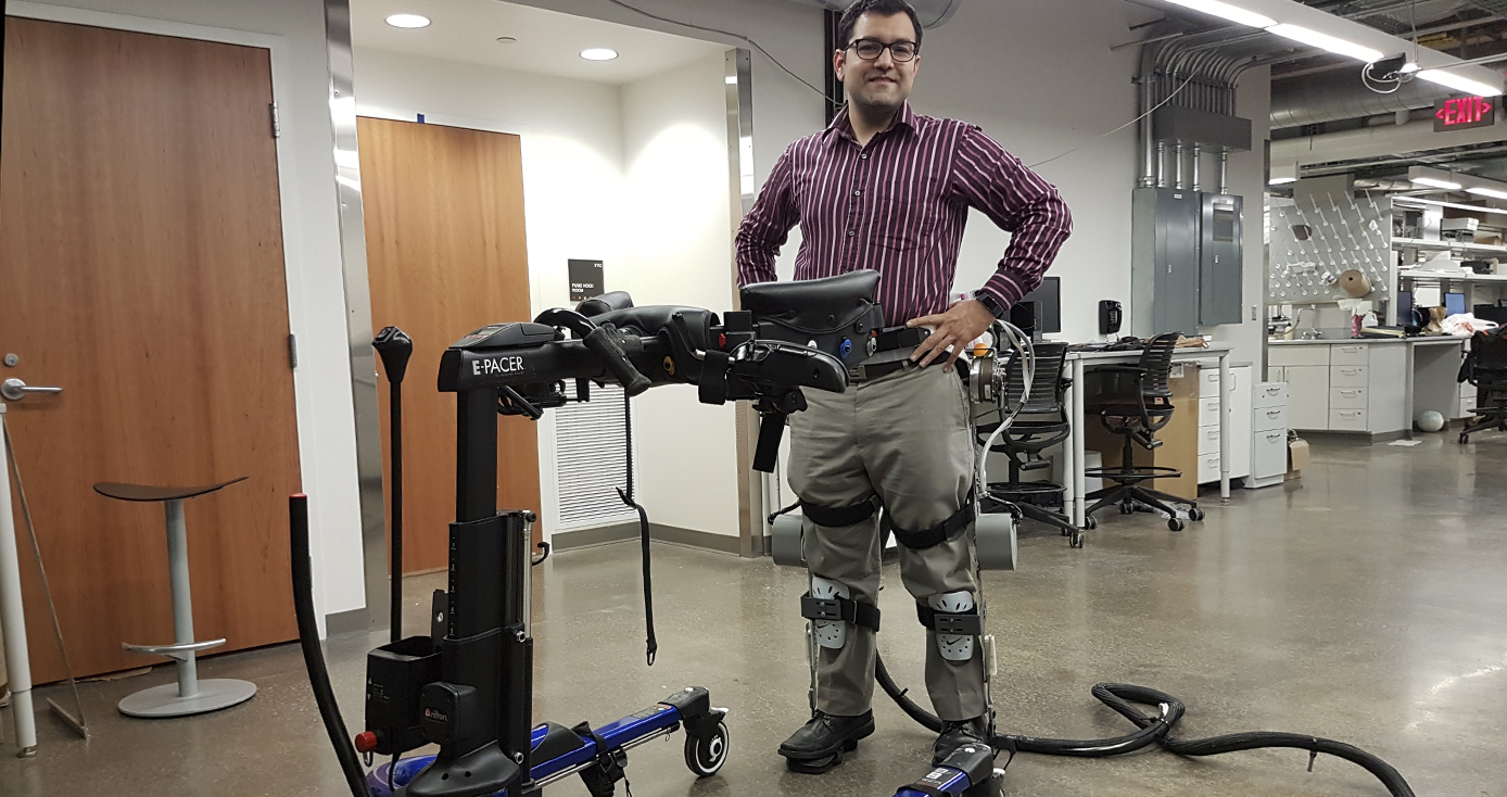 Sharma with his hands on his hips wearing the exoskeleton leg braces