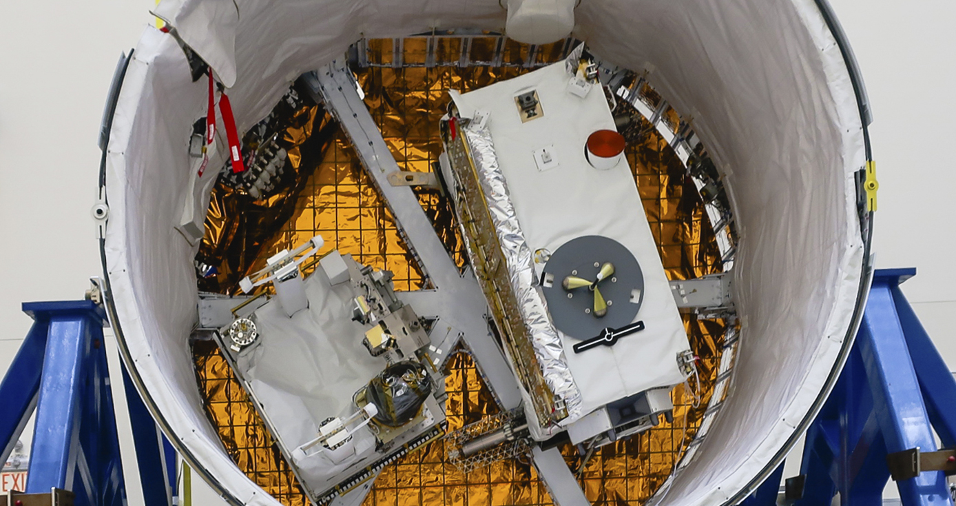 a round white cylinder with technical equipment and copper colored foil inside