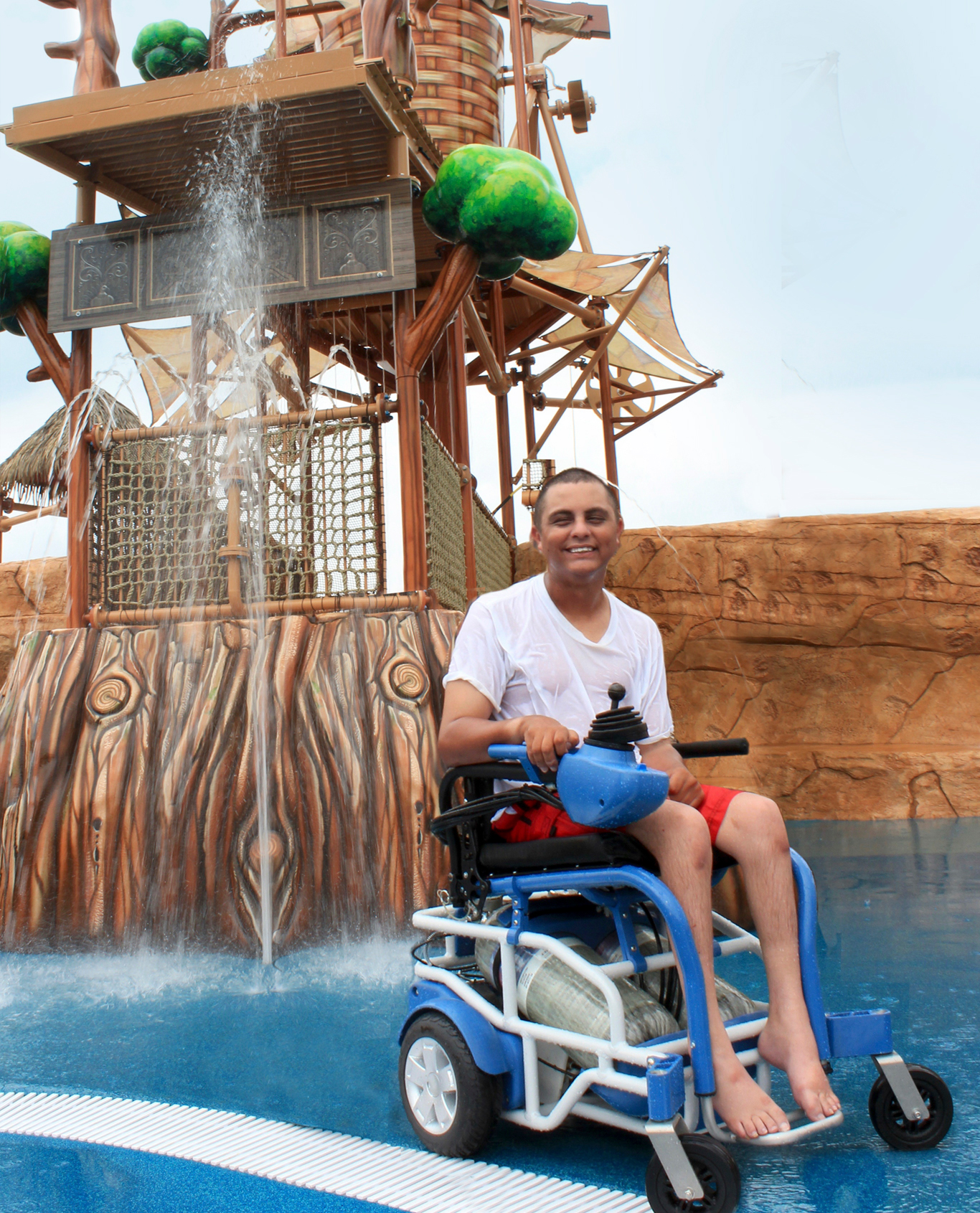 young man in a white shirt using a blue and black PneuChair