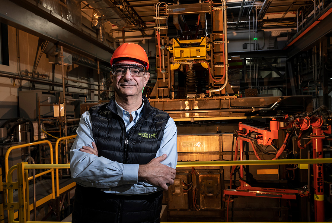 Carneiro, wearing a hardhat, standing in an industrial factory