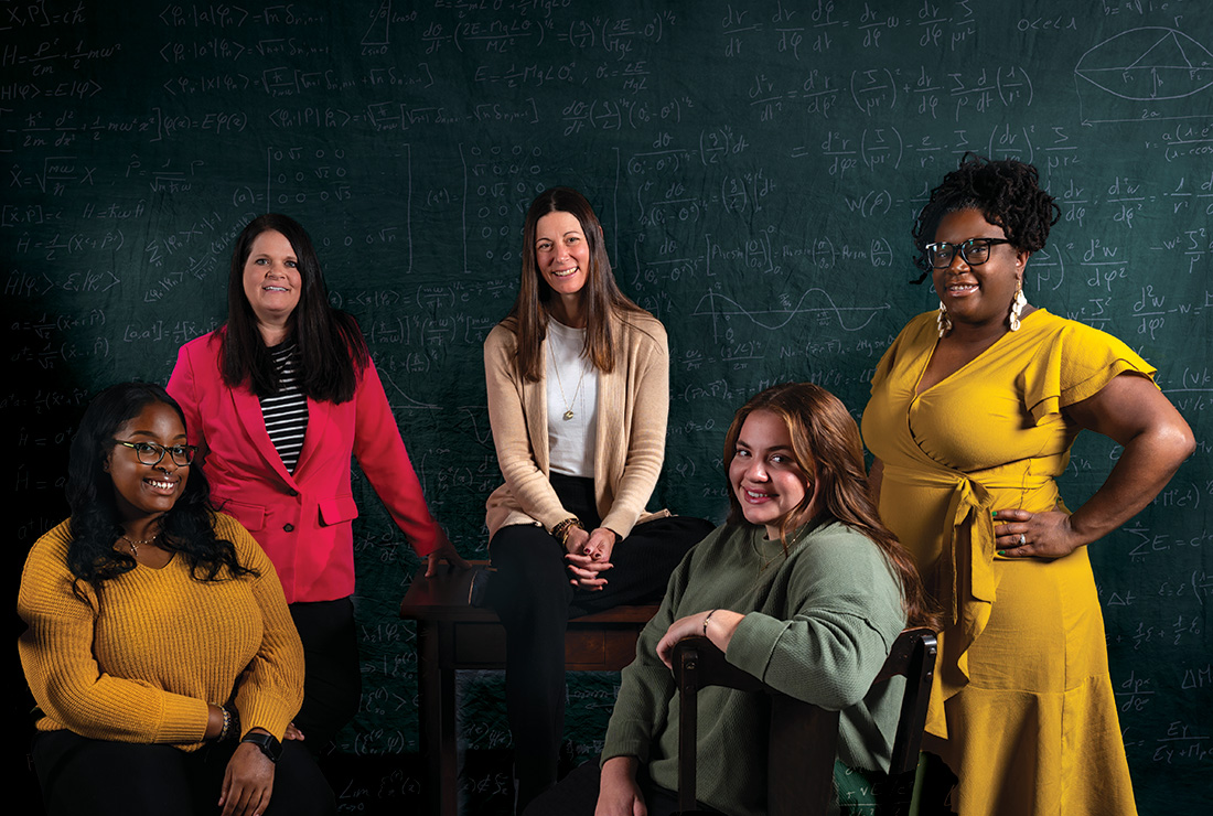 Five people in front of a chalkboard