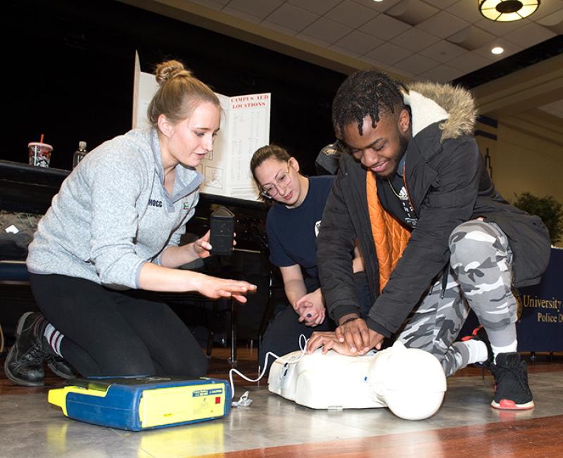 Students using an AED on a medical dummy