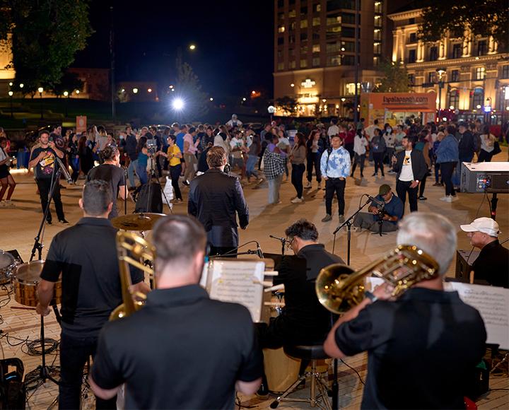 Large crowd enjoying band performance at CLAS festival