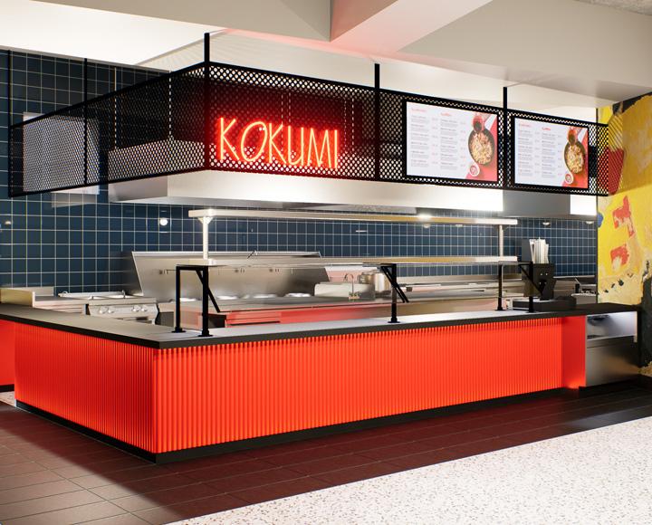 neon lights spelling KOKUMI above a serving station