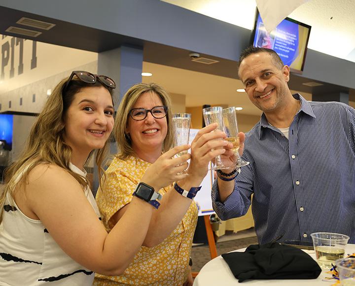Three people cheers with champagne flutes