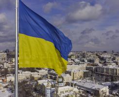 a Ukrainian flag over a city