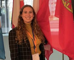 Furmansky in front of a row of flags