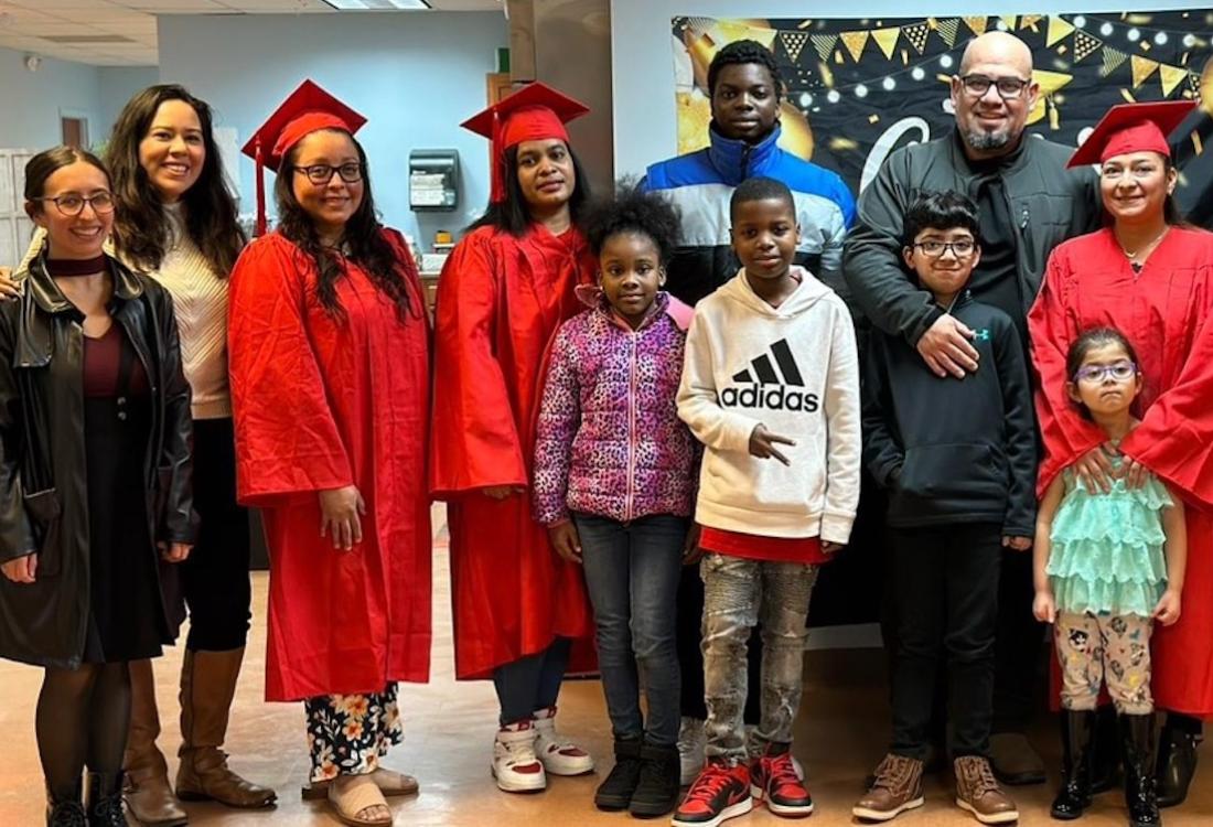 A group of adults and children pose for a photo.