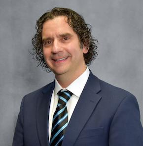 Headshot of a man in a suit.