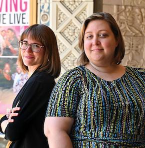 Two women, one with crossed arms, posing for the camera.