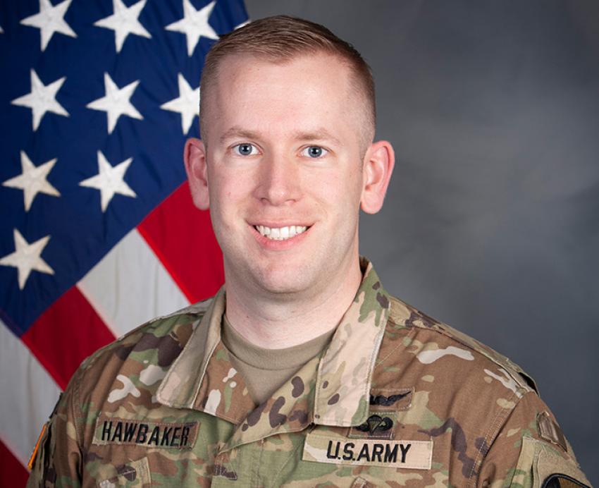 Daniel Hawbaker headshot with American flag in the background